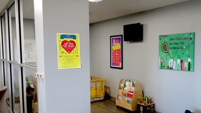 Interior hallway with activity posters and children's toys