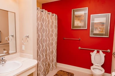 Bright bathroom with red walls and fixtures