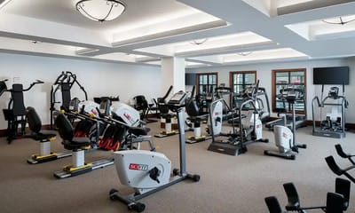 Well-equipped fitness room with exercise machines.