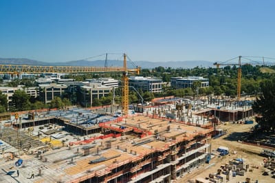 Construction site with cranes and building areas visible.