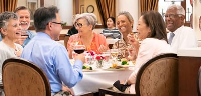 Residents enjoying a meal together at a dining table.