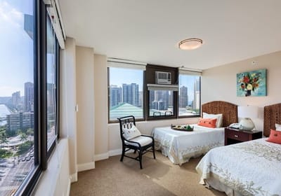 Bright resident room with two beds and city view