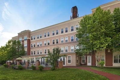 Exterior view of a senior living facility with greenery