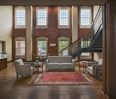 Bright common area with seating and staircase