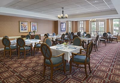 Dining room with well-set tables and chairs