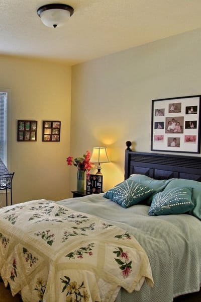 Cozy bedroom with floral bedding and family photos