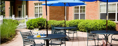 Outdoor patio area with tables and umbrellas