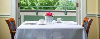 Dining table set with flowers and tea service