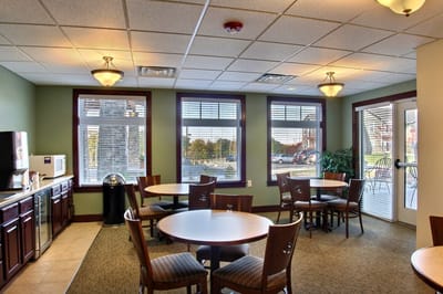 Common area with tables and chairs in a cozy setting