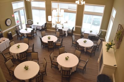 Dining area with set tables and floral arrangements