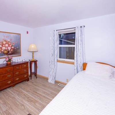 Brightly decorated private resident room with a flower painting