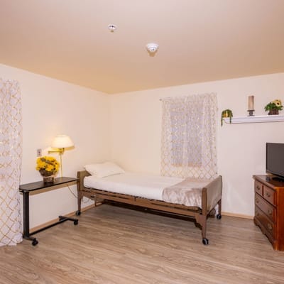 A private resident room with a bed and natural light