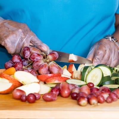 A person preparing fresh fruit in the kitchen