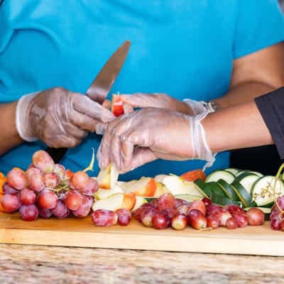 Residents preparing fresh fruit in the kitchen