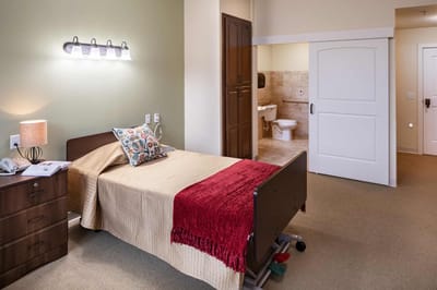 A private resident room with a bed and bathroom