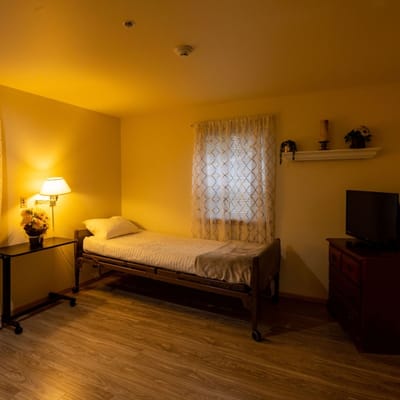 Private resident room with a bed and TV