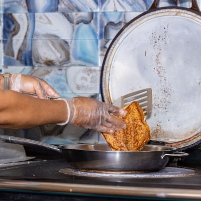 A person cooking food in a kitchen
