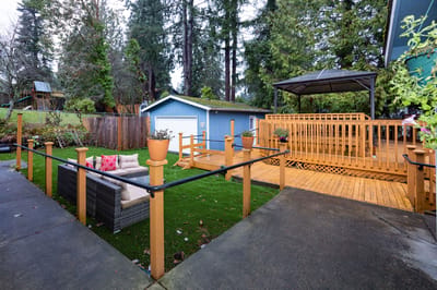Outdoor seating area with a wooden deck and garden
