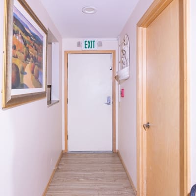 Interior hallway with exit sign and decorative painting