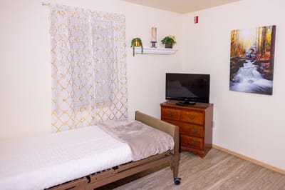 A cozy bedroom setup with a bed and television
