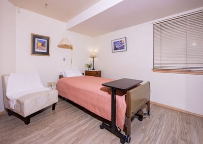 Cozy resident room with a bed and seating area