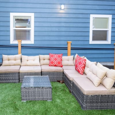 Outdoor seating area with cushions and a table