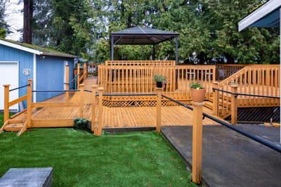 Outdoor wooden deck with seating area and gazebo