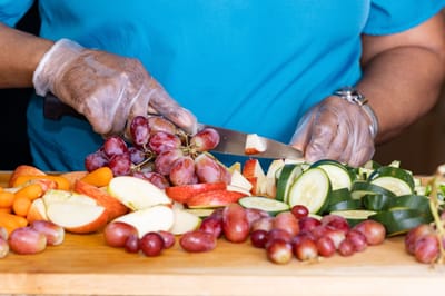 Close-up of hands preparing fresh fruits and vegetables