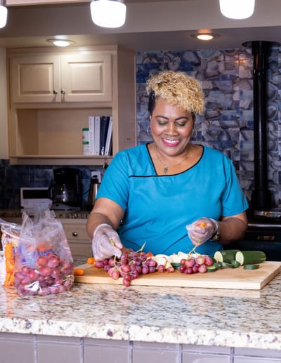 Staff member preparing food in a kitchen