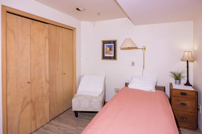 Cozy private resident room with bed and chair