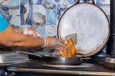 A staff member preparing food in the kitchen