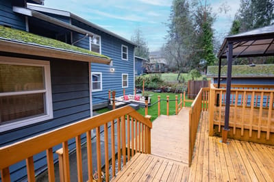 Wooden deck leading to a garden area behind the facility