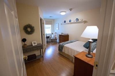 Cozy resident room with a bed and chair