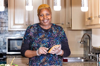 Staff member preparing food in a kitchen setting