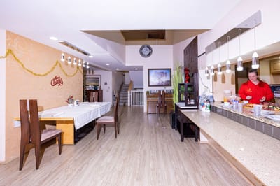 Bright dining area with food and staff attending