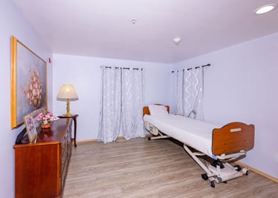 Private resident room with bed and nightstand