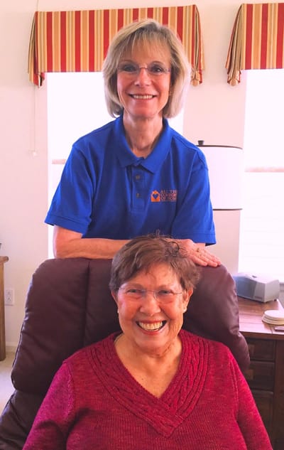 Staff member with a resident in a cozy interior setting