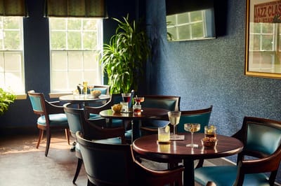 Dining area with tables, drinks, and snacks