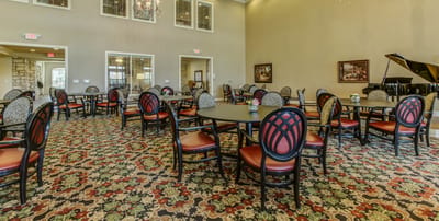 Dining area with tables and chairs in an activity room