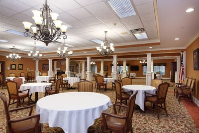 Dining area with tables and chairs, well-lit ambiance