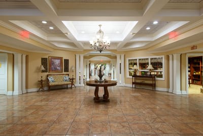Bright and welcoming common area with chandelier and decor