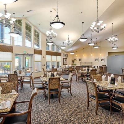 Bright dining room with tables and chairs set for meals