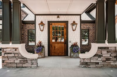 Entrance of Westminster Memory Care with flowers and lanterns