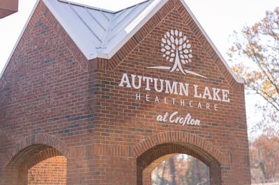 Facility logo displayed on brick structure