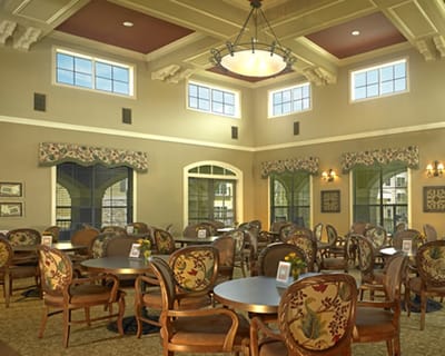 Bright dining area with floral chairs and large windows