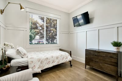 Private resident room with floral bedding and modern decor