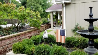 Outdoor view of the facility with garden and American flag.