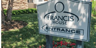 Entrance sign of Francis House with landscaping