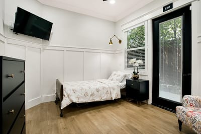 Cozy interior of a resident room with a bed and furniture