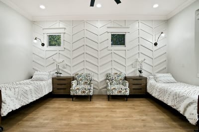 Comfortable resident room with two beds and seating area